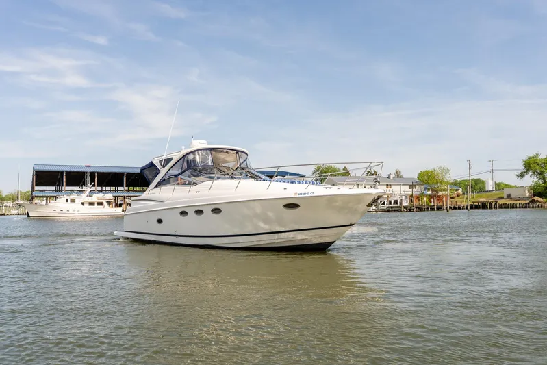  Yacht Photos Pics 2008 Regal Commodore 4060 yacht cruising on a calm river under a clear blue sky.