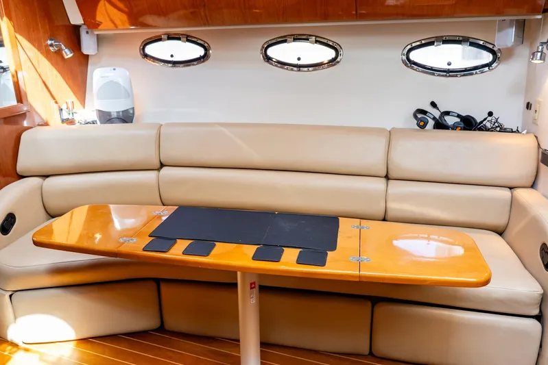  Yacht Photos Pics Luxurious interior of 2008 Regal Commodore 4060 yacht with beige leather seating and wooden table.