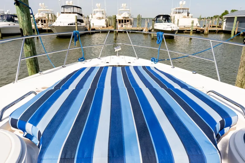  Yacht Photos Pics 2008 Regal Commodore 4060 yacht with striped deck, docked at marina.