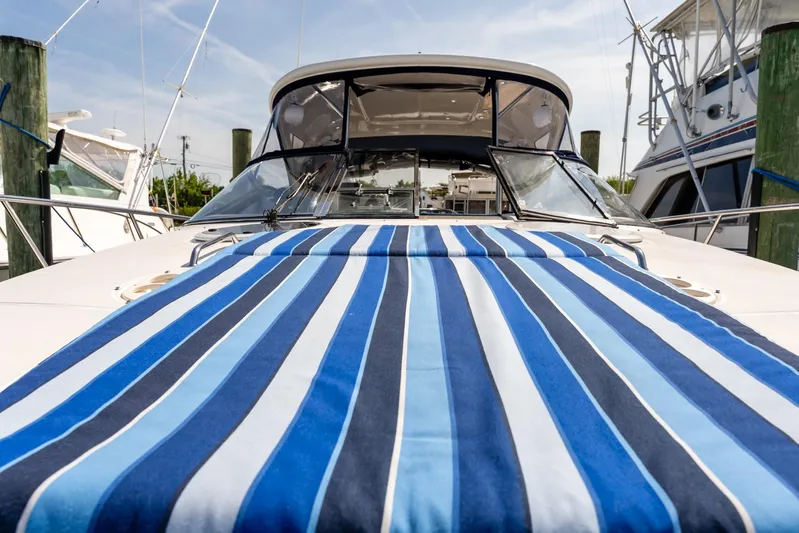  Yacht Photos Pics 2008 Regal Commodore 4060 yacht with blue striped deck cover at marina.