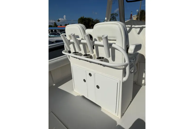 28-563 Brokerage Higgins Yacht Photos Pics 2021 Regulator 28 boat console with rod holders and storage compartments.