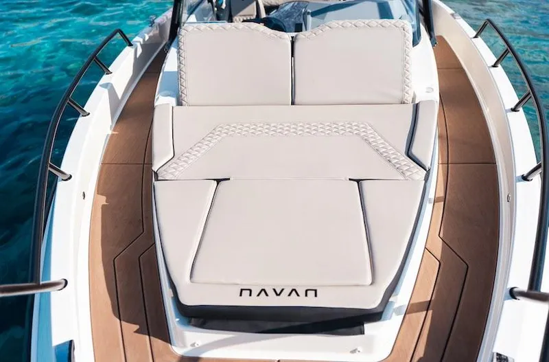 Yacht Photos Pics Luxurious Navan S30 boat deck with cushioned seating, 2025 model, on clear blue water.