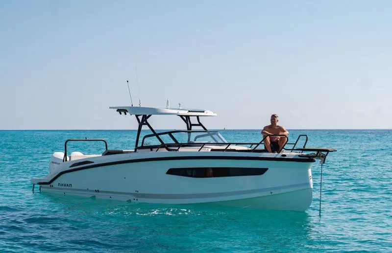  Yacht Photos Pics 2025 Navan S30 boat on clear blue water with a person seated on deck.