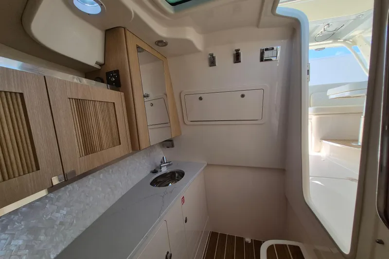 345-624 Yacht Photos Pics Interior of 2026 Grady-White Freedom 345 boat, featuring modern cabinetry and sink.
