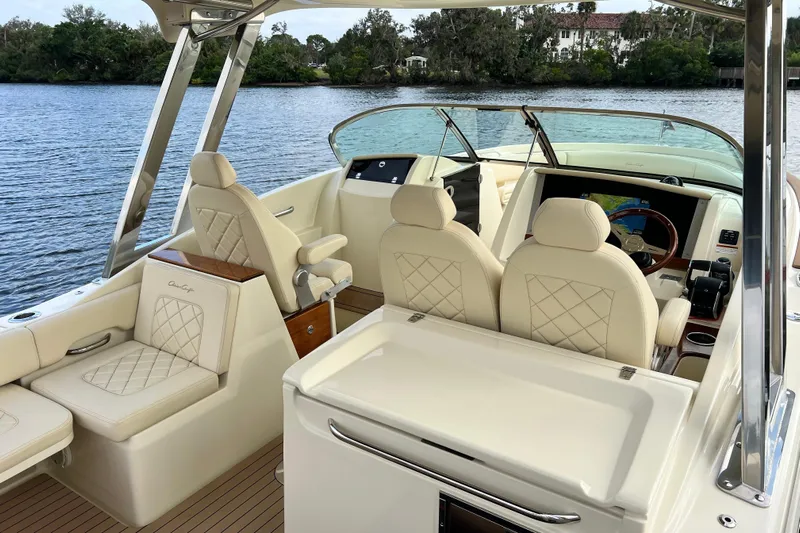 Yacht Photos Pics 2023 Chris-Craft Calypso 30 boat interior with luxurious seating and modern dashboard.