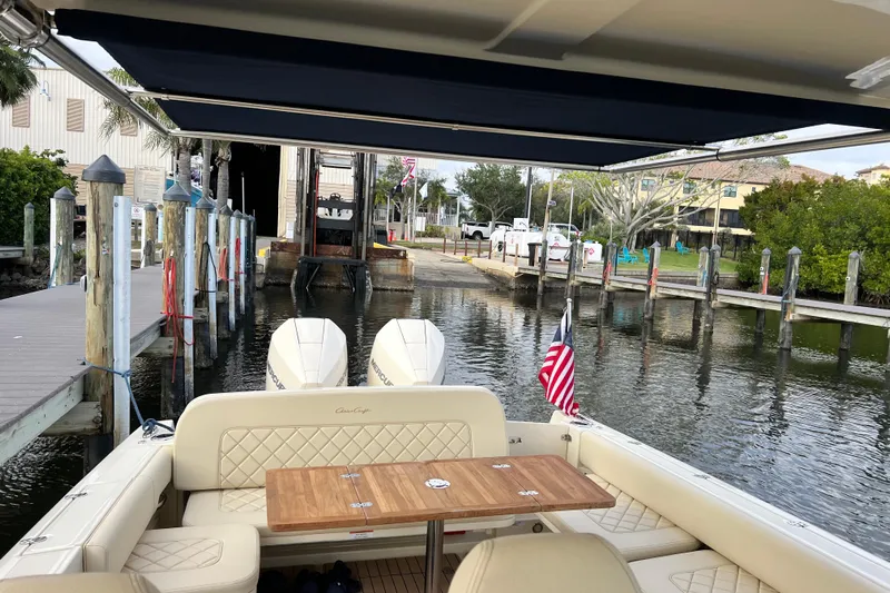  Yacht Photos Pics 2023 Chris-Craft Calypso 30 boat docked, featuring elegant seating and dual outboard engines.