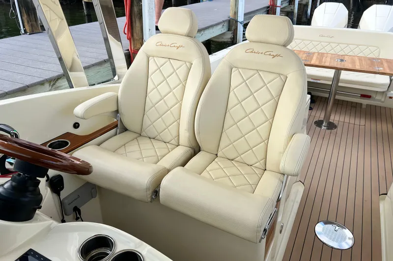  Yacht Photos Pics Luxurious 2023 Chris-Craft Calypso 30 boat interior with elegant cream leather seating.