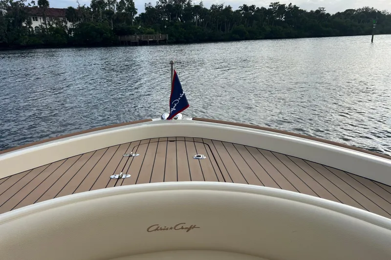  Yacht Photos Pics 2023 Chris-Craft Calypso 30 boat deck with water view and flag.