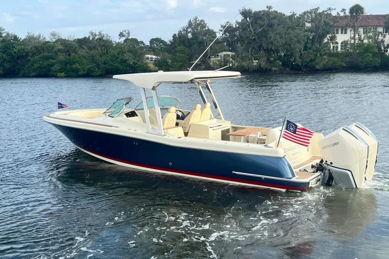  Yacht Photos Pics 2023 Chris-Craft Calypso 30 boat cruising on a serene waterway.