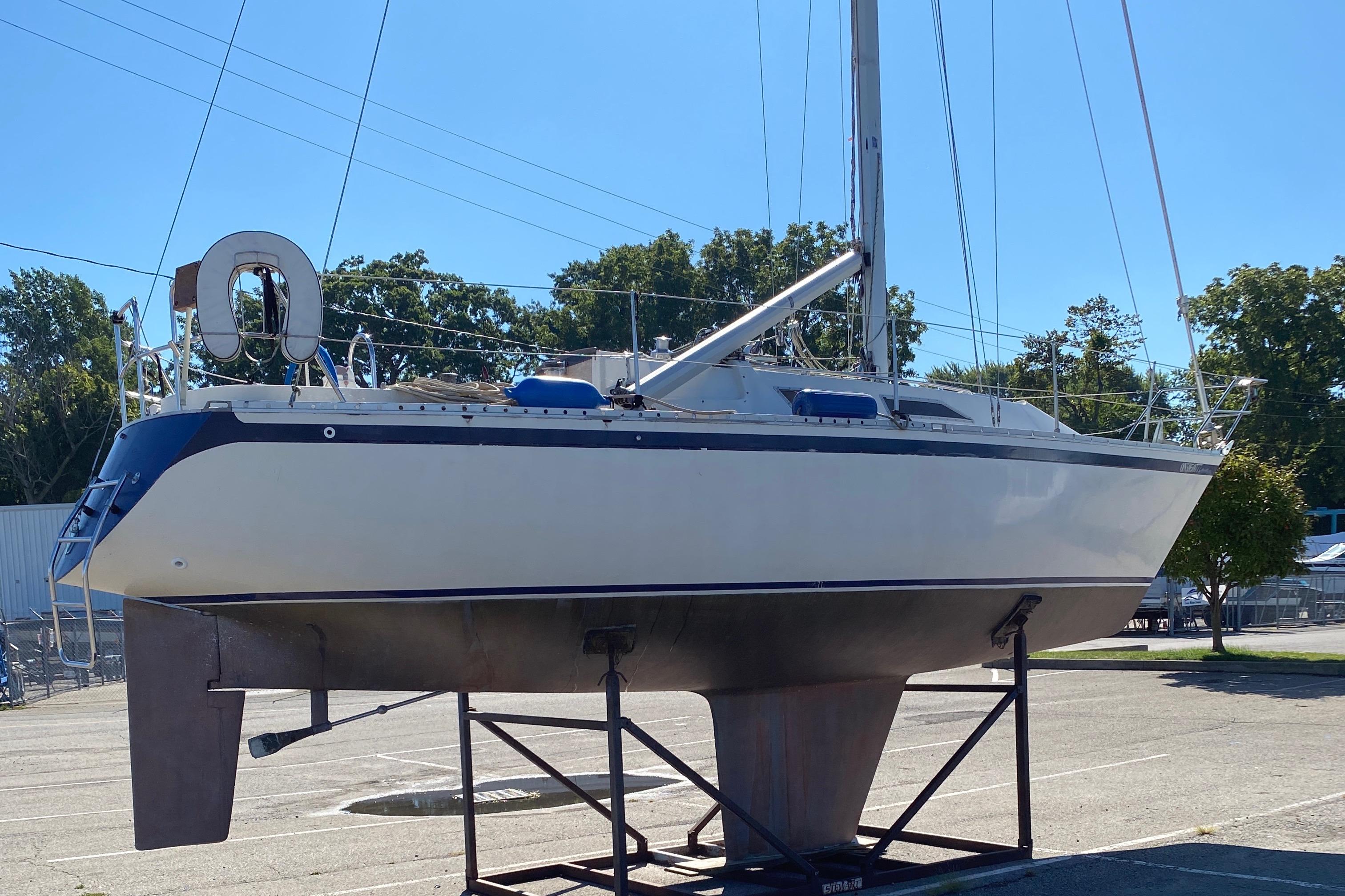 1985 CS 33 Sloop sailboat on a stand in a sunny marina.