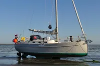 Sloop sailboat Puffin 30 (9M) generation 2, 2012, anchored on calm water.