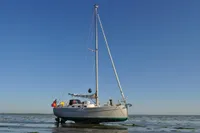 Sloop sailboat Puffin 30 (9M) generation 2, 2012, anchored on a calm sea.