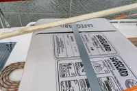 Liferaft on Puffin 30 Sloop, 2012 model, secured on deck near water.