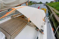Sailing yacht Puffin 30 (9M) Sloop, 2012 model, docked with deck canopy.