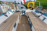 Cockpit of 2012 Puffin 30 Sloop with wooden deck, ropes, and safety equipment.