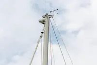 Mast of 2012 Puffin 30 Sloop with rigging against cloudy sky.