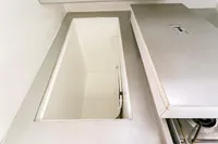 Interior view of a 2012 Puffin 30 Sloop, featuring a storage compartment.