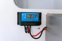 Solar charge controller on Puffin 30 Sloop, 2012 model, displaying 13.8V with USB ports.