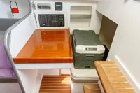 Interior of 2012 Puffin 30 Sloop, featuring navigation station and storage area.