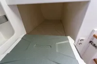 Cozy cabin interior of 2012 Puffin 30 Sloop with Alpicool cooler.