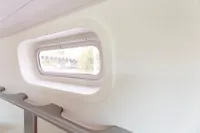 Interior view of a 2012 Puffin 30 Sloop, featuring a sleek cabin window.
