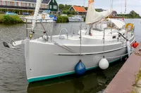 2012 Puffin 30 Sloop docked in a serene marina setting.