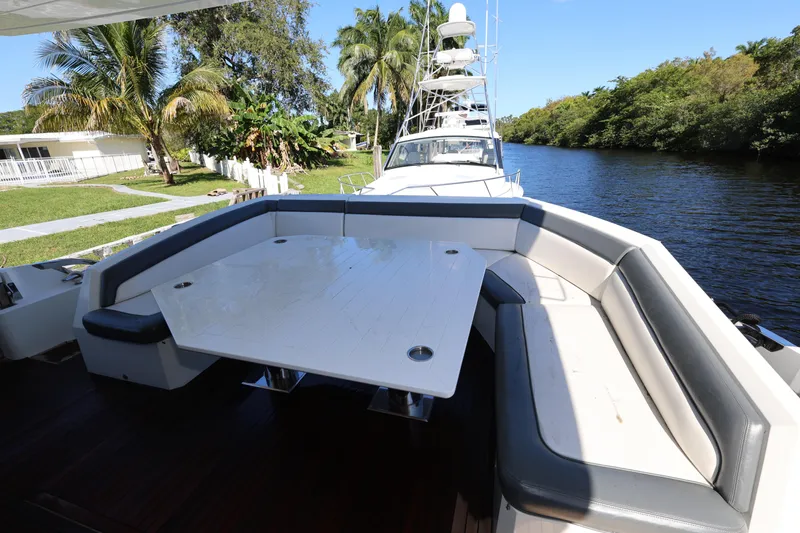  Yacht Photos Pics 2019 Galeon 650 Sky yacht with spacious outdoor seating and table by a scenic river.