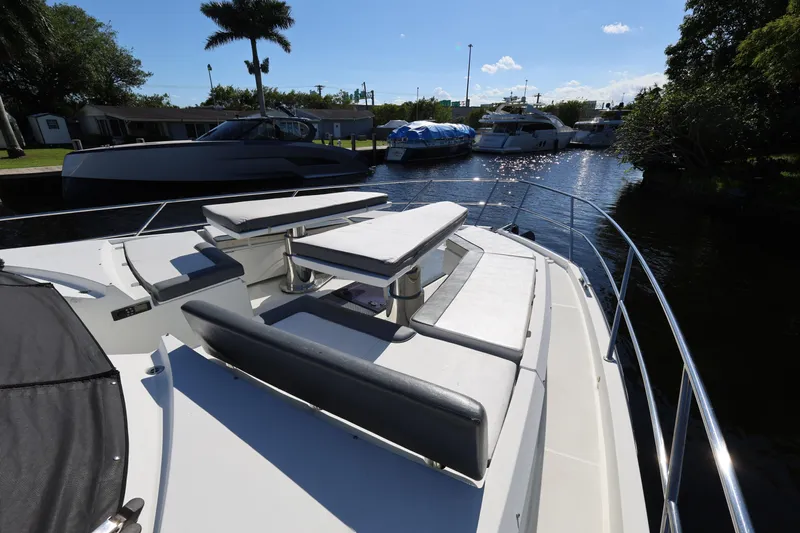  Yacht Photos Pics 2019 Galeon 650 Sky yacht with spacious deck seating, docked in a sunny marina.