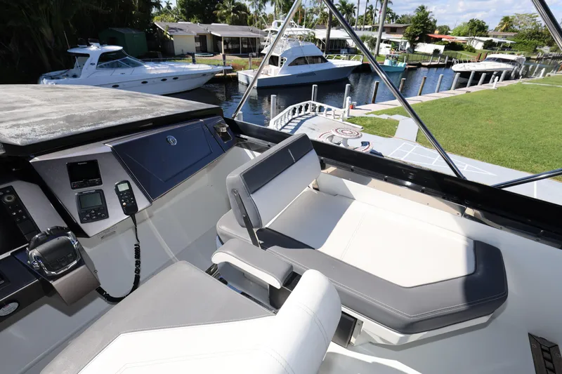  Yacht Photos Pics Cockpit view of 2019 Galeon 650 Sky yacht docked by a canal.