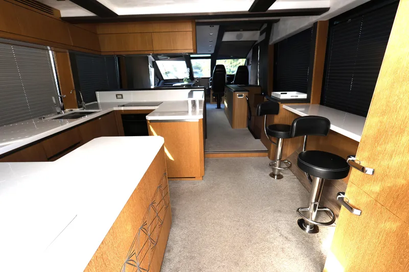  Yacht Photos Pics Luxurious interior of 2019 Galeon 650 Sky yacht with modern kitchen and seating area.