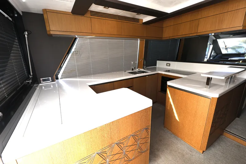  Yacht Photos Pics Luxurious kitchen interior of 2019 Galeon 650 Sky yacht with modern wood cabinetry.