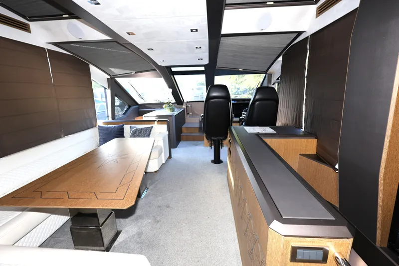  Yacht Photos Pics Luxurious interior of 2019 Galeon 650 Sky yacht with modern seating and wooden accents.
