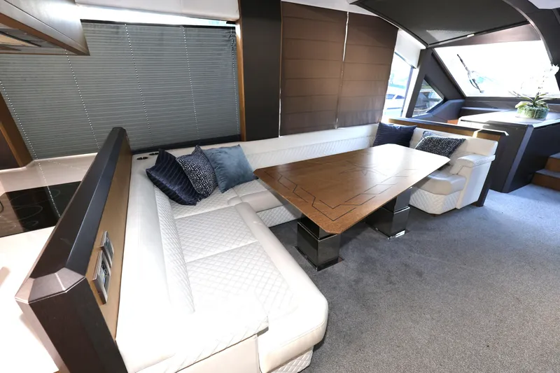  Yacht Photos Pics Luxurious interior of 2019 Galeon 650 Sky yacht with elegant seating and wooden table.