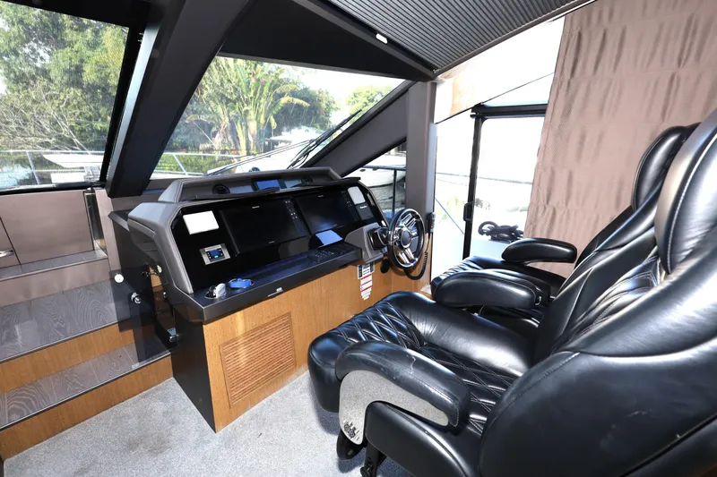 Yacht Photos Pics Luxurious interior of 2019 Galeon 650 Sky yacht with leather seating and modern helm.