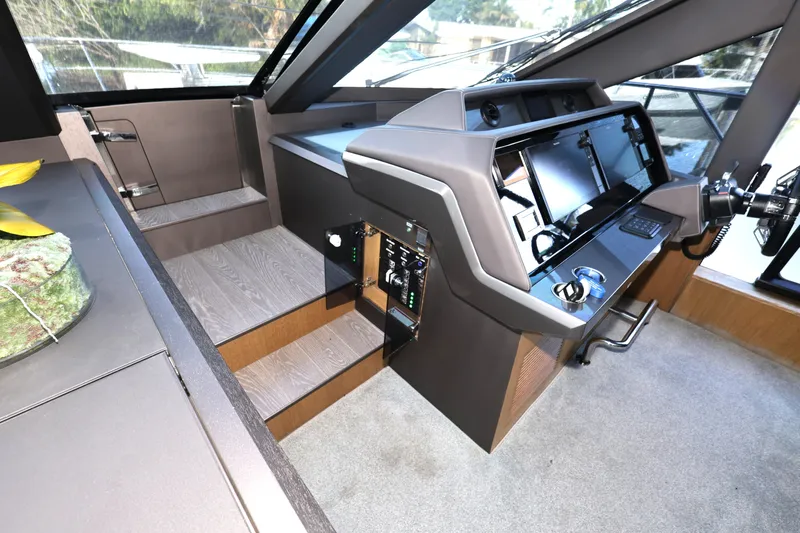  Yacht Photos Pics Interior helm of 2019 Galeon 650 Sky yacht with modern controls and sleek design.