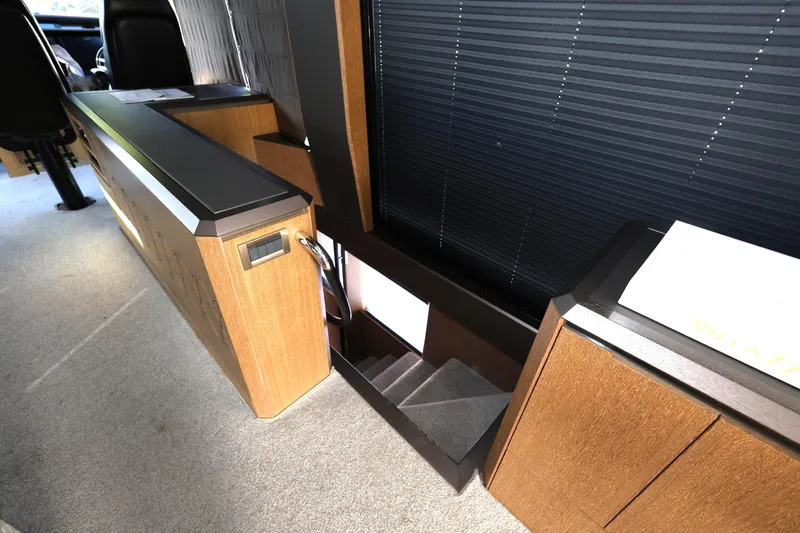  Yacht Photos Pics Interior of 2019 Galeon 650 Sky yacht with wooden cabinetry and carpeted stairs.