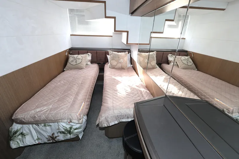  Yacht Photos Pics Luxurious twin cabin interior on 2019 Galeon 650 Sky yacht, featuring elegant bedding and mirrored walls.