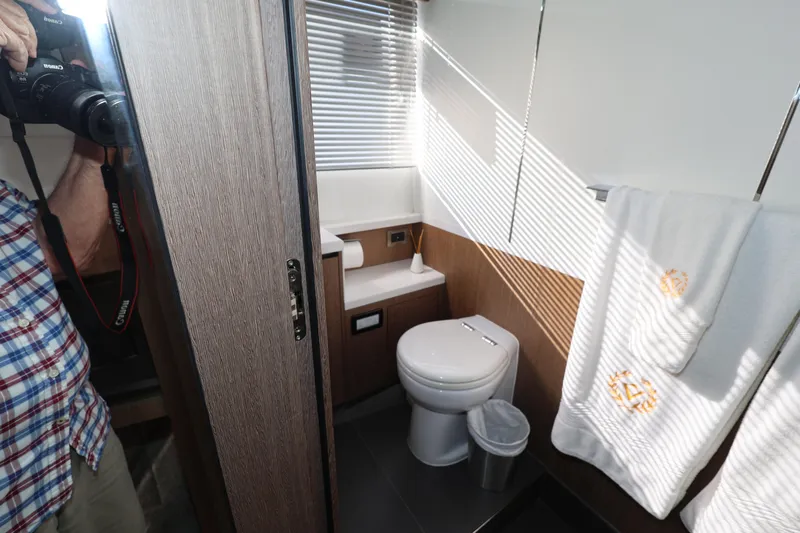  Yacht Photos Pics Bathroom interior of 2019 Galeon 650 Sky yacht with modern fixtures and towels.