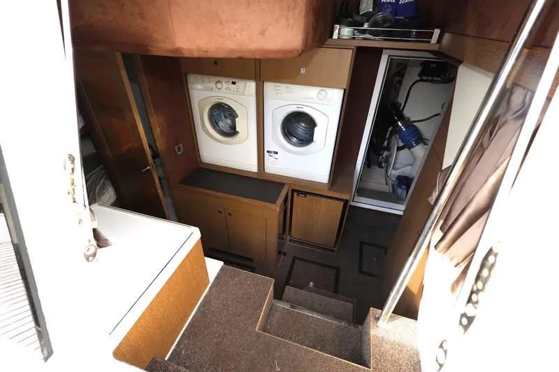  Yacht Photos Pics Laundry area inside 2019 Galeon 650 Sky yacht with washer and dryer.