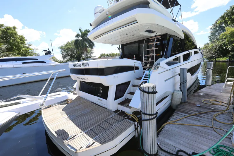  Yacht Photos Pics 2019 Galeon 650 Sky yacht docked, featuring sleek design and spacious deck.
