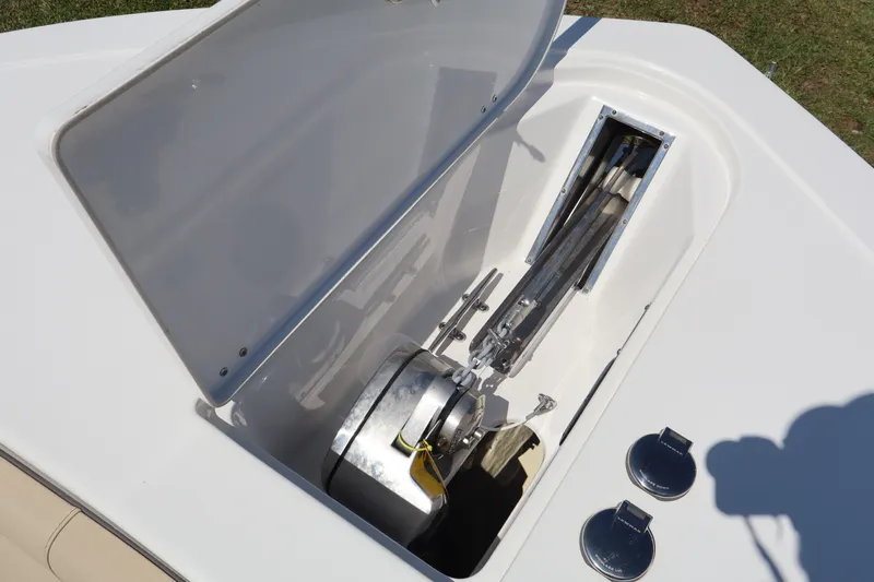  Yacht Photos Pics Open anchor compartment on 2022 Tidewater 272 LXF boat, showcasing anchor storage and mechanism.