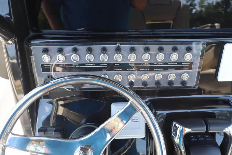  Yacht Photos Pics Control panel of 2022 Tidewater 272 LXF boat with steering wheel and switches.