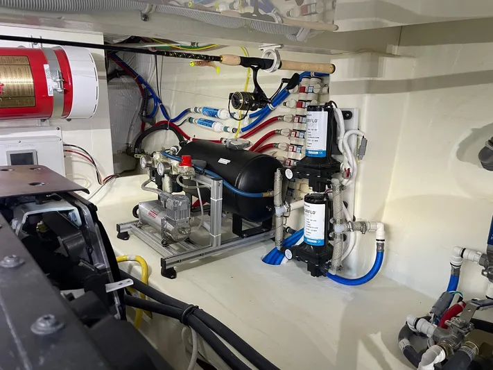 Salty Suite Yacht Photos Pics Engine room of 2023 Tiara Yachts C44 Coupe with water filtration system and fire extinguisher.