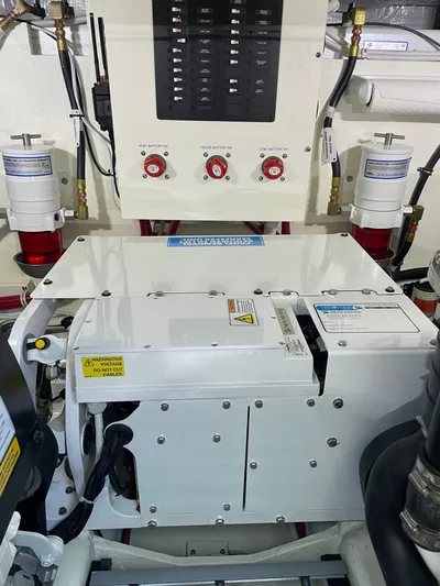 Salty Suite Yacht Photos Pics Engine room of 2023 Tiara Yachts C44 Coupe with control panel and machinery.