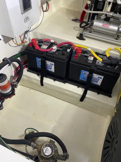 Salty Suite Yacht Photos Pics 2023 Tiara Yachts C44 Coupe engine room with dual batteries and wiring.