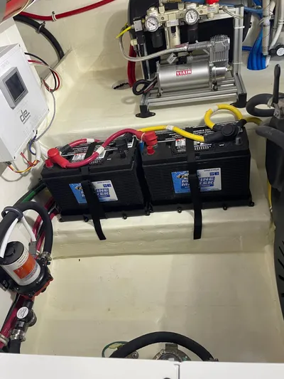 Salty Suite Yacht Photos Pics Battery compartment of 2023 Tiara Yachts C44 Coupe with dual batteries and wiring.