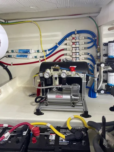 Salty Suite Yacht Photos Pics Engine room of a 2023 Tiara Yachts C44 Coupe with electrical and mechanical components.