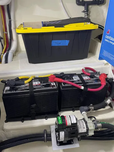 Salty Suite Yacht Photos Pics Battery compartment of a 2023 Tiara Yachts C44 Coupe with wiring and components.