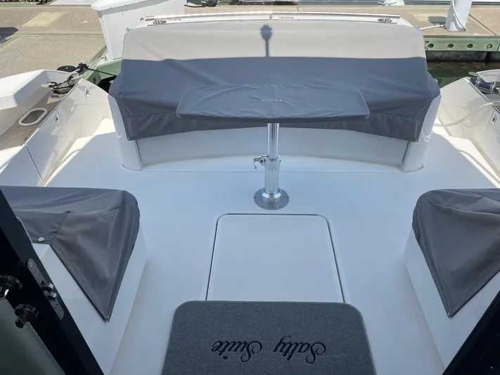 Salty Suite Yacht Photos Pics 2023 Tiara Yachts C44 Coupe cockpit with seating and table.