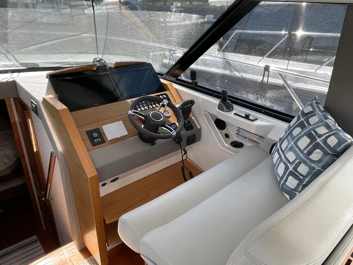 Salty Suite Yacht Photos Pics 2023 Tiara Yachts C44 Coupe helm station with modern controls and comfortable seating.